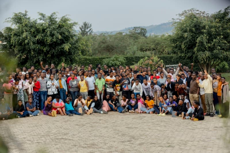 Youth listening to teaching under tents