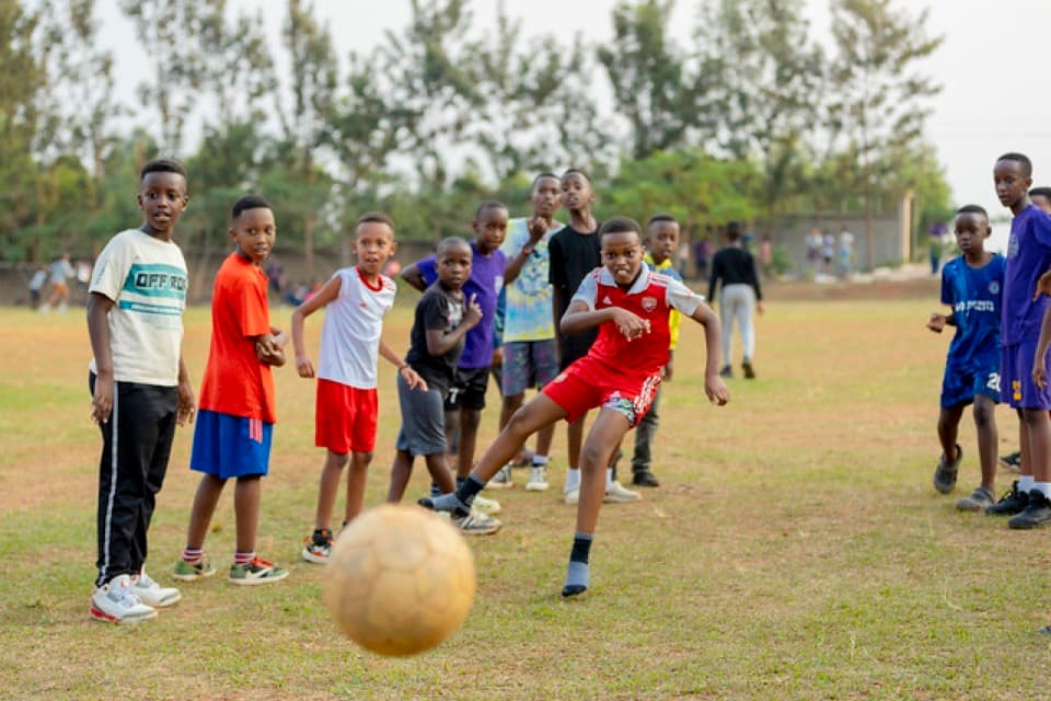 Youth seated together during an outdoor camp session